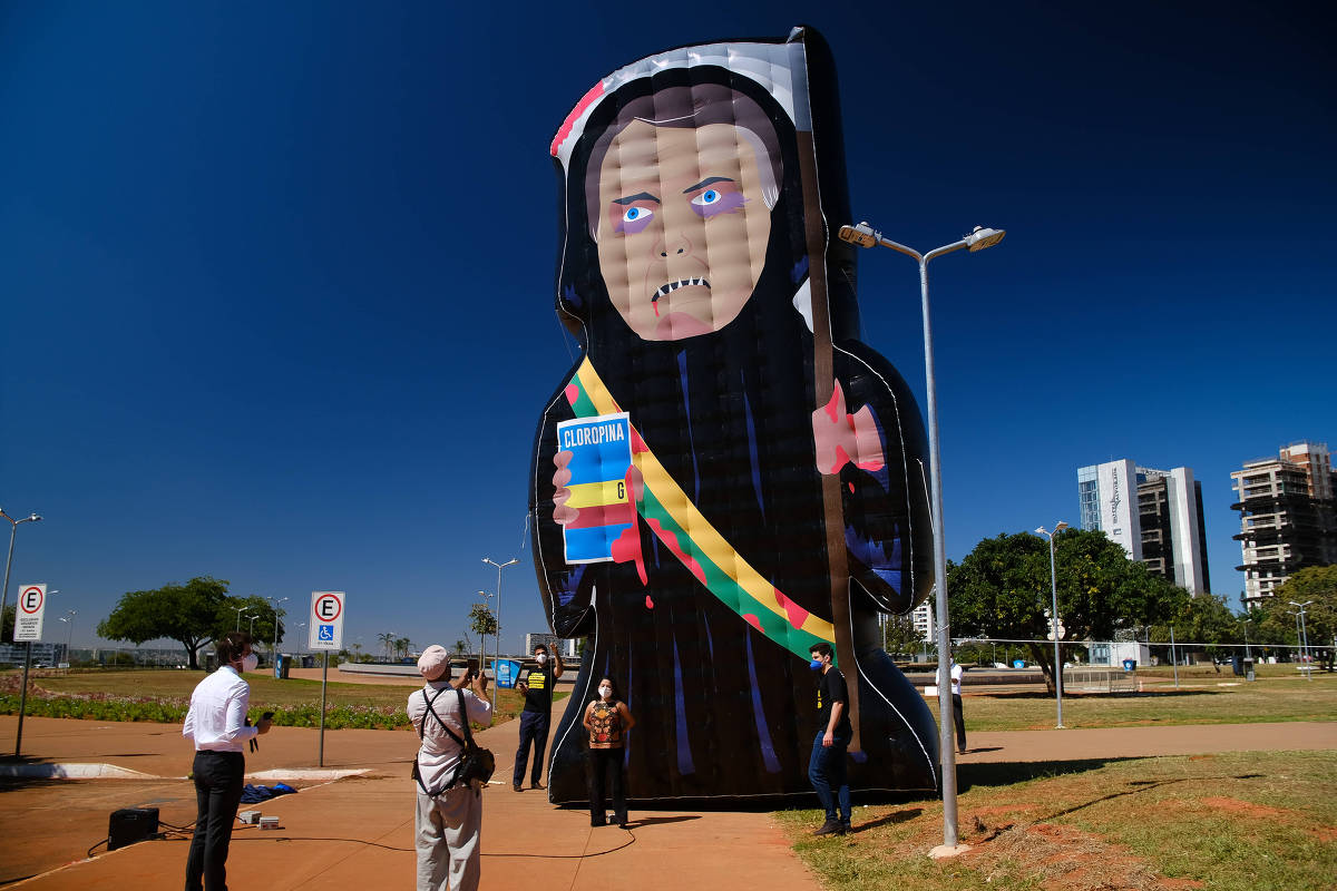Manifestantes inflam um boneco chamado de Capitão Cloroquino, representando o presidente Jair Bolsonaro, ao lado da Torre de TV de Brasília, na região central da cidade