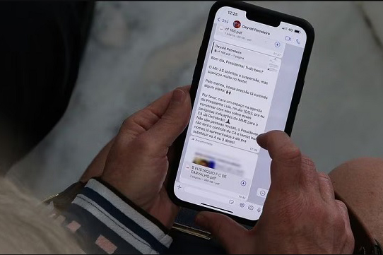 Gleisi lê mensagem no WhatsApp durante cerimônia de lançamento do novo Bolsa Família